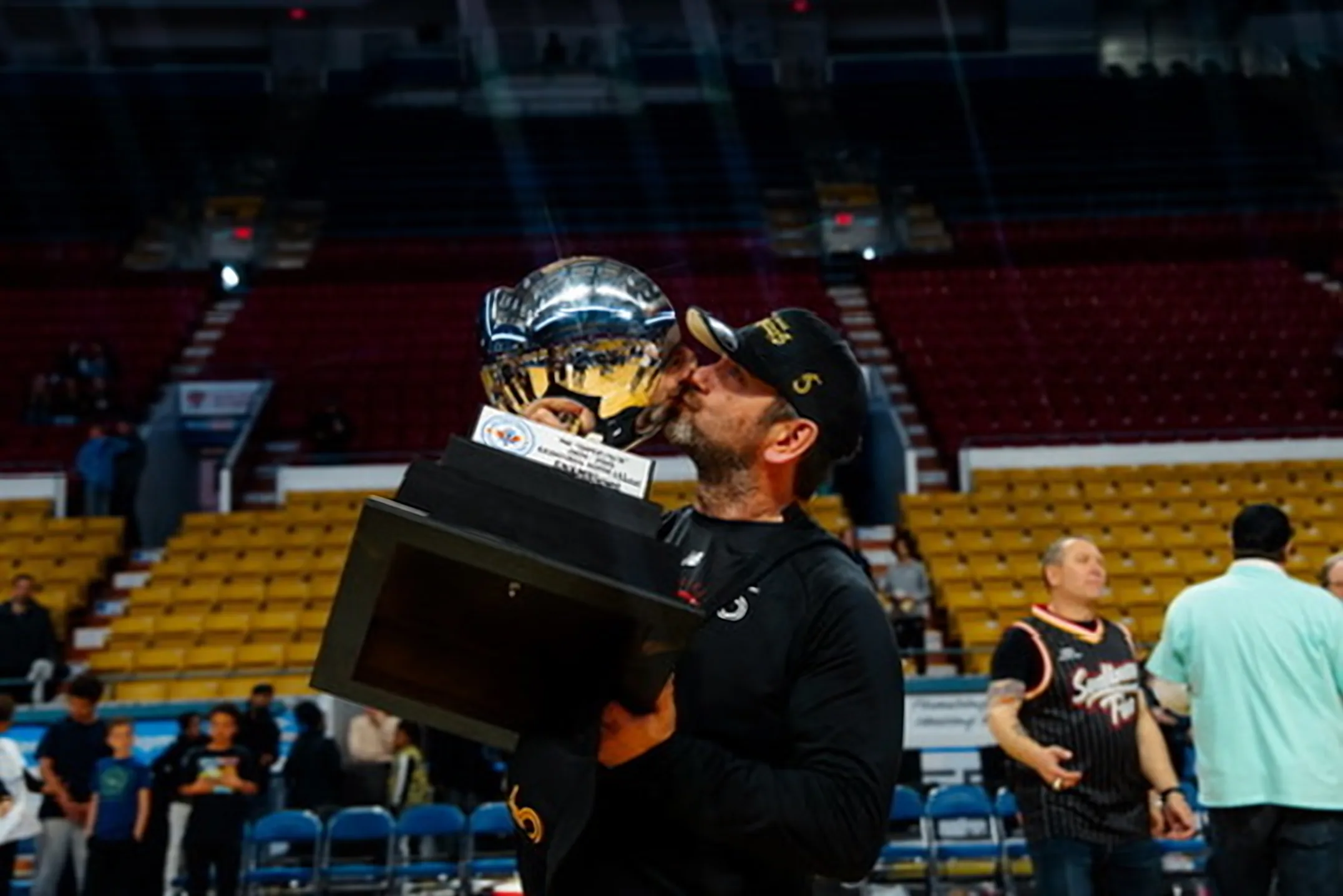 Troy Beauregard kissing the Basketball Super League trophy on the court